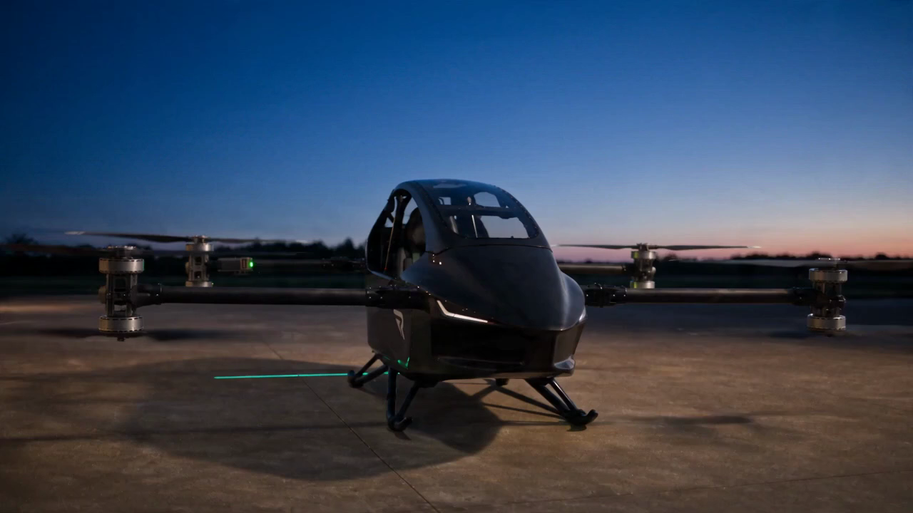 Black REVTOL aircraft in flight above a mountain horizon